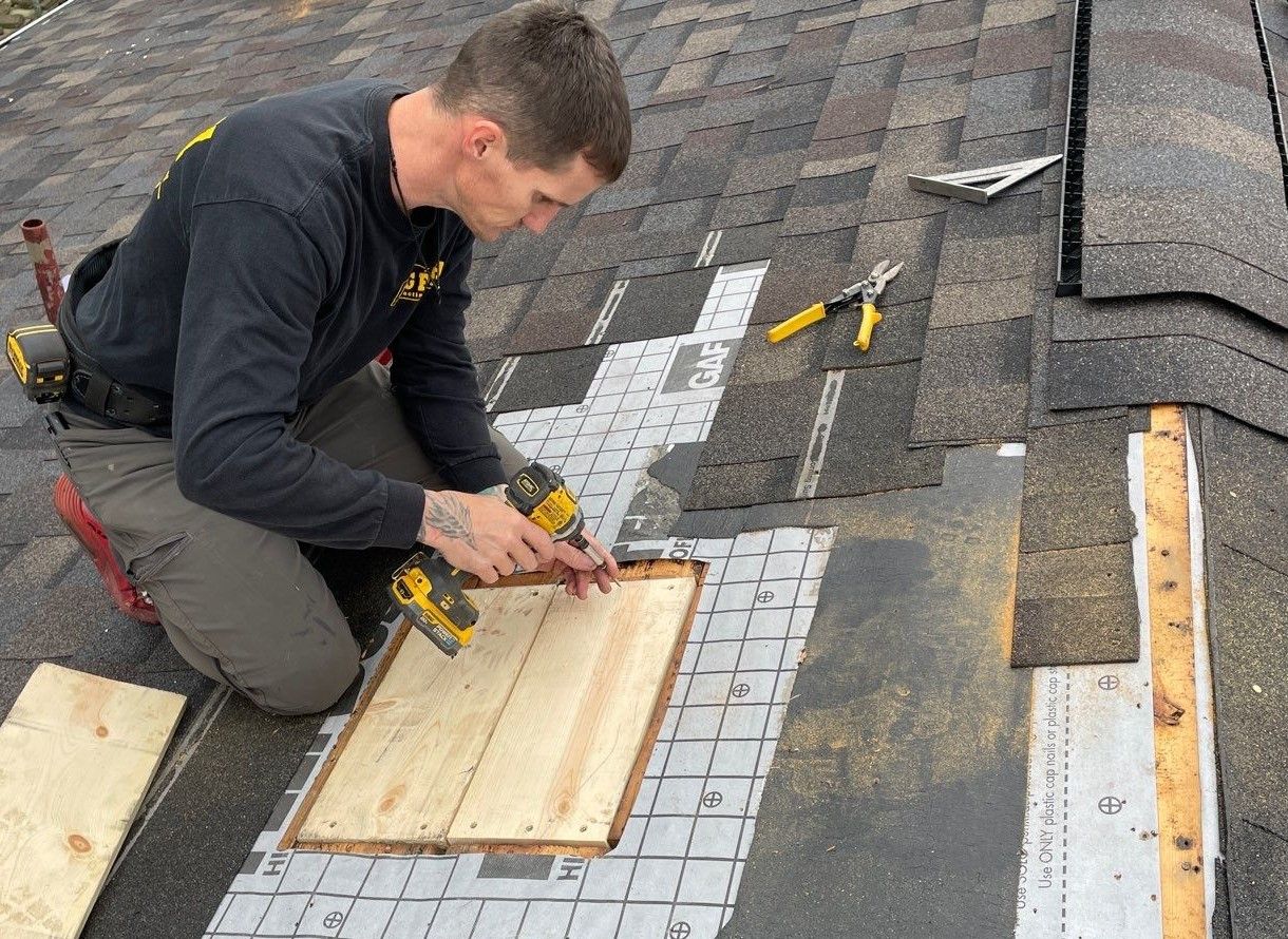 Big Fish Roofing contractor repairing shingles on residential roof in Pittsburgh PA